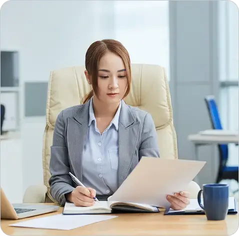 medium-shot-young-asian-woman-suit-sitting-desk-office-reading-document 1 medium-shot-young-asian-woman-suit-sitting-desk-office-reading-document 1